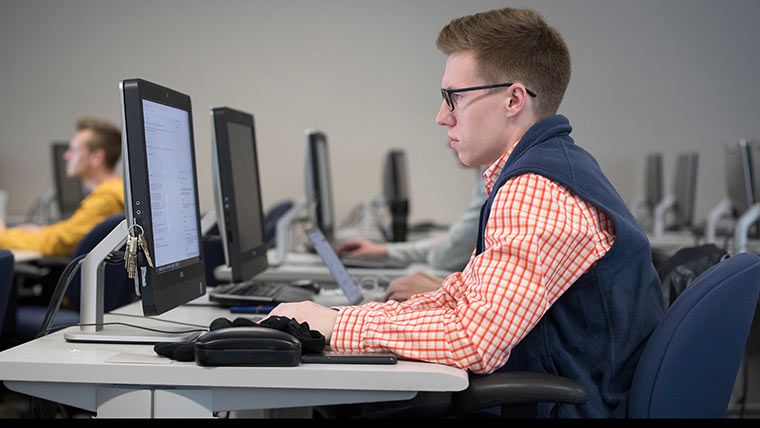 Student seated at a computer.